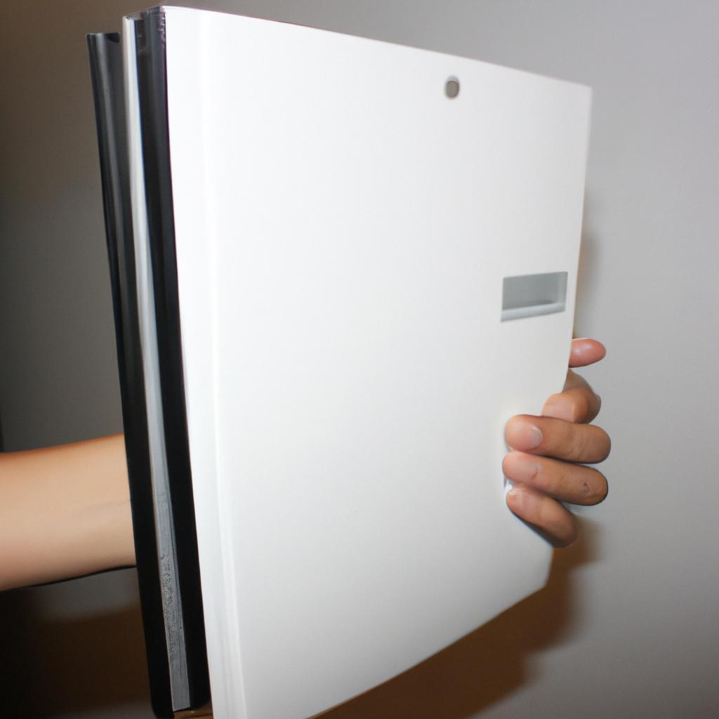 Person holding a computer book